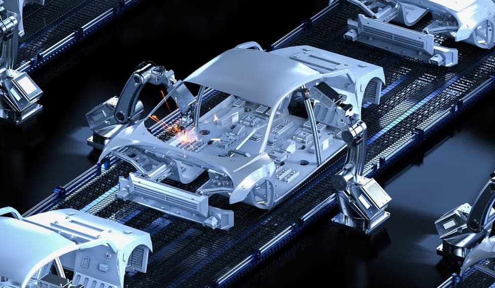 An automotive production line where robot welders assemble a car body